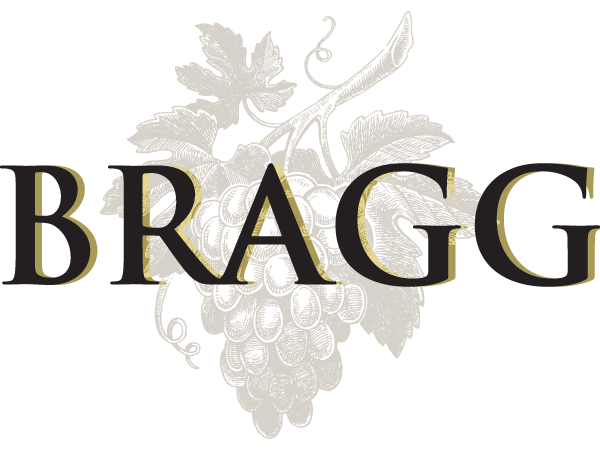 Bragg wordmark set on a watermark style cluster of grapes